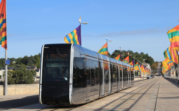 Tram in Tours, flanked by local flags