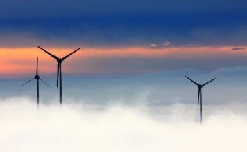 Wind turbines above low clouds