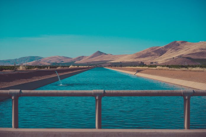 Water in a reservoir set against an arid landscape